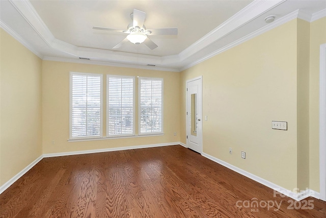 unfurnished room with hardwood / wood-style flooring, crown molding, a raised ceiling, and ceiling fan