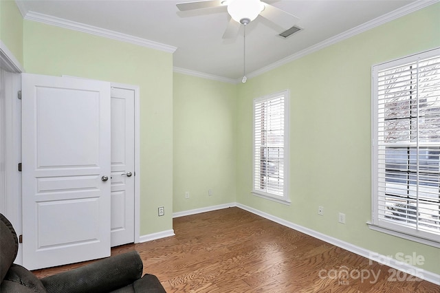 living area with ceiling fan, ornamental molding, and hardwood / wood-style floors