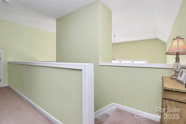 stairs with carpet floors, lofted ceiling, and ceiling fan