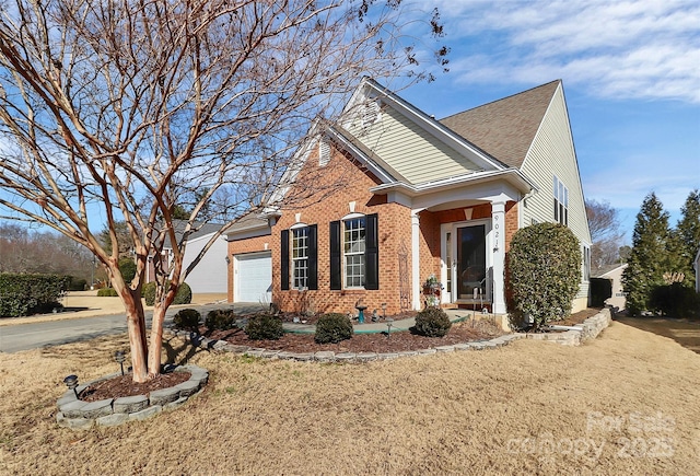 view of side of home with a garage and a yard