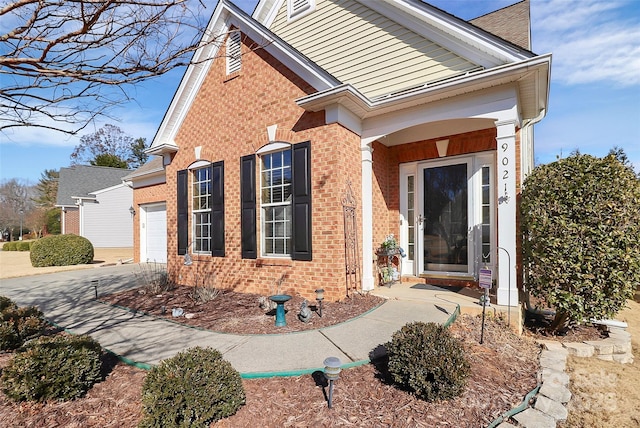 doorway to property with a garage