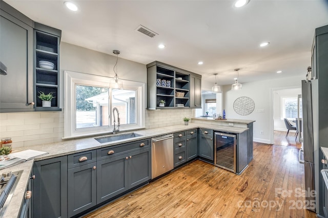 kitchen featuring kitchen peninsula, gray cabinetry, dishwasher, wine cooler, and pendant lighting