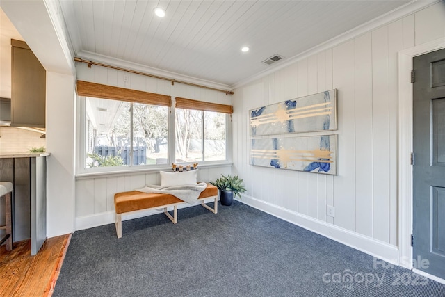 sitting room featuring wood-type flooring and ornamental molding