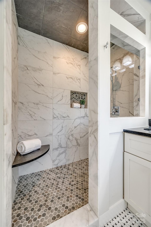 bathroom featuring vanity and tiled shower