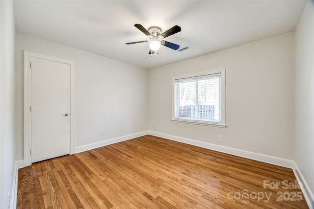 spare room with hardwood / wood-style flooring and ceiling fan