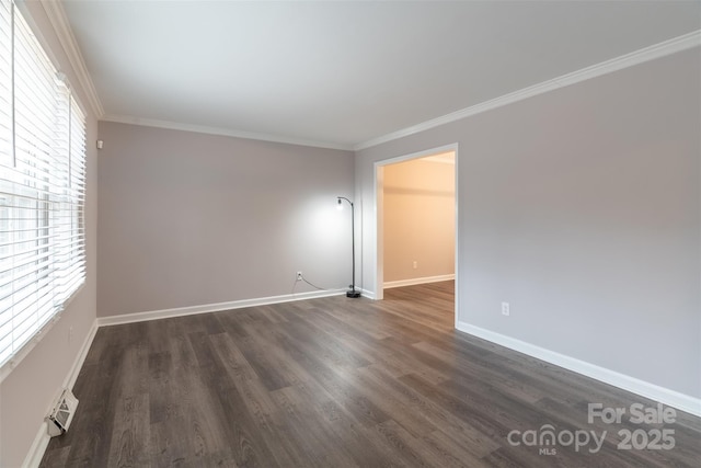 empty room with crown molding, plenty of natural light, and dark hardwood / wood-style floors