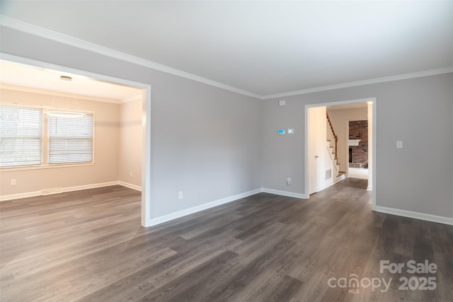 spare room with dark hardwood / wood-style flooring and ornamental molding