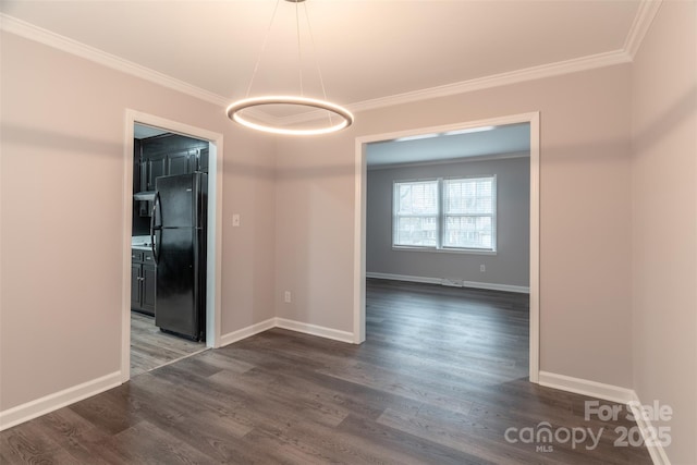 spare room with crown molding and dark wood-type flooring