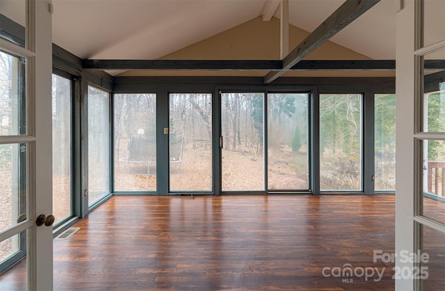 unfurnished sunroom with vaulted ceiling with beams