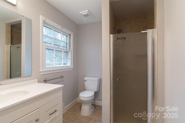 bathroom with vanity, toilet, walk in shower, and tile patterned floors