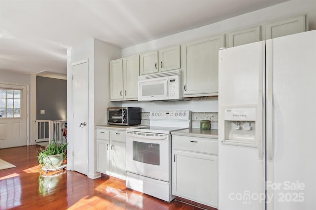 kitchen with dark hardwood / wood-style flooring, white cabinets, and white appliances