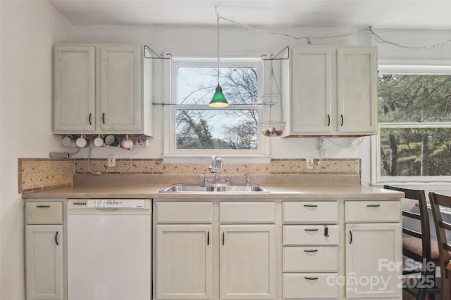 kitchen with a wealth of natural light, sink, and white dishwasher