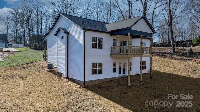 exterior space featuring a lawn, cooling unit, and a balcony