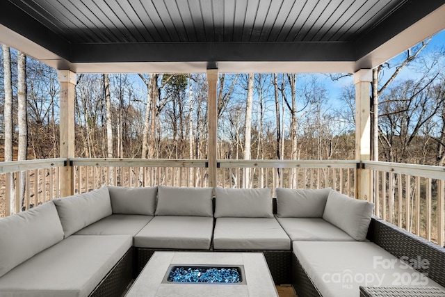 exterior space featuring an outdoor living space with a fire pit