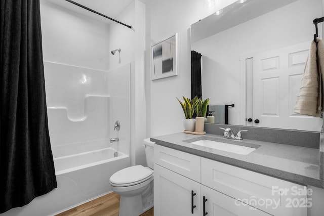 full bathroom with toilet, shower / bath combo, hardwood / wood-style flooring, and vanity