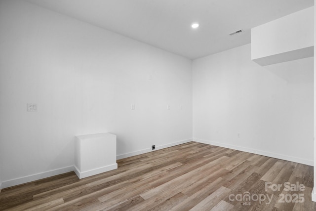 unfurnished room with hardwood / wood-style flooring