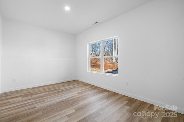 unfurnished room with light hardwood / wood-style floors