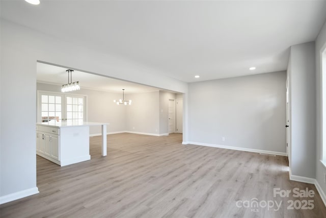 interior space with a chandelier and light wood-type flooring