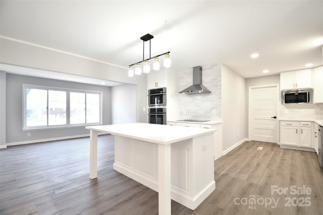 kitchen featuring decorative backsplash, white cabinetry, and wall chimney exhaust hood