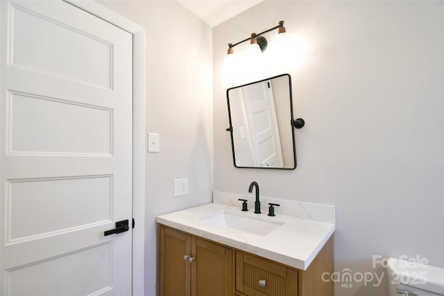 bathroom with vanity and toilet