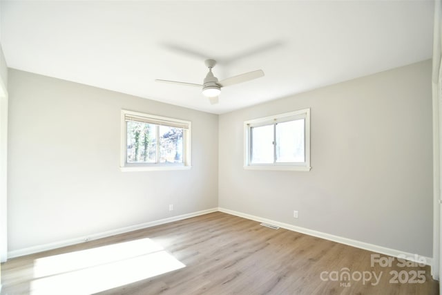 empty room featuring ceiling fan and light hardwood / wood-style flooring