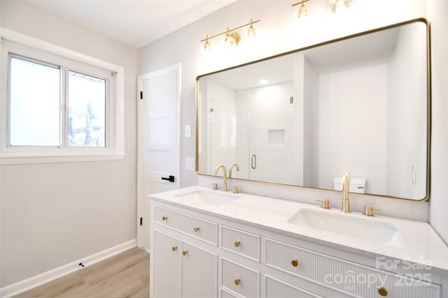 bathroom with hardwood / wood-style floors, vanity, toilet, and an enclosed shower