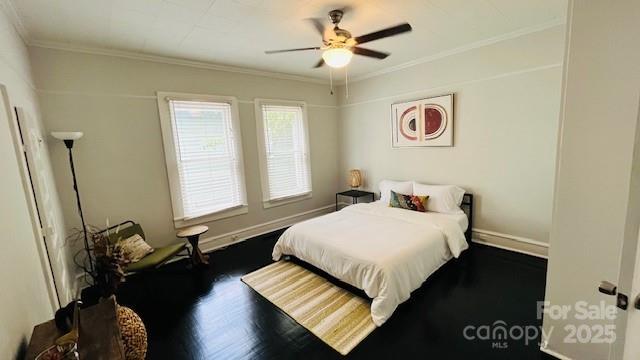 bedroom with ceiling fan, dark hardwood / wood-style floors, and ornamental molding