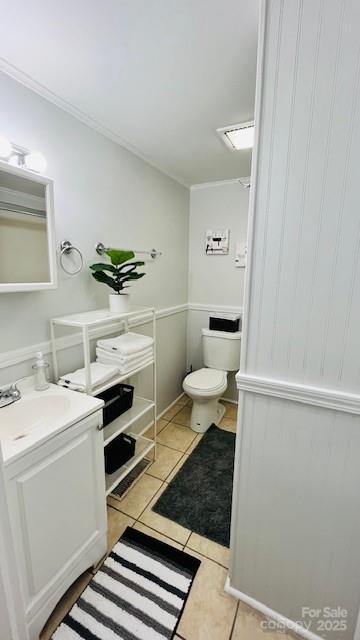 bathroom featuring tile patterned floors, vanity, and toilet