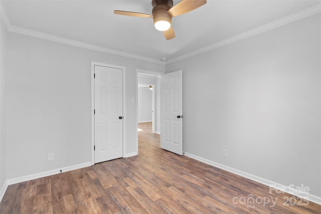 unfurnished room featuring ceiling fan, dark hardwood / wood-style flooring, and ornamental molding