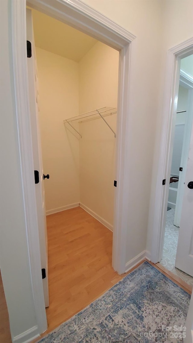 clothes washing area with light hardwood / wood-style flooring