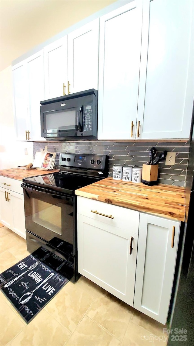 kitchen with black appliances, wood counters, and white cabinetry