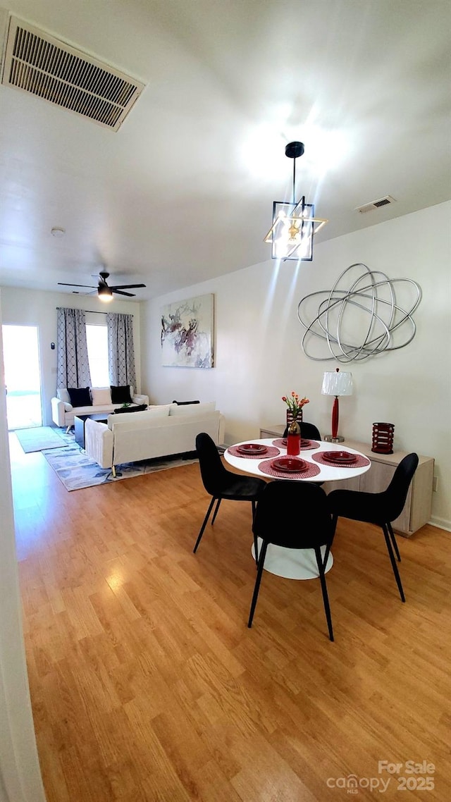 dining space featuring ceiling fan and light hardwood / wood-style floors