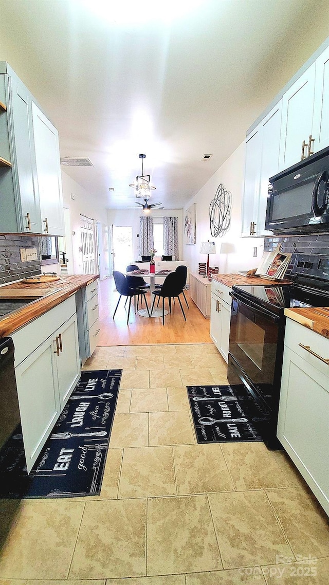 kitchen featuring ceiling fan, butcher block countertops, white cabinets, and black appliances