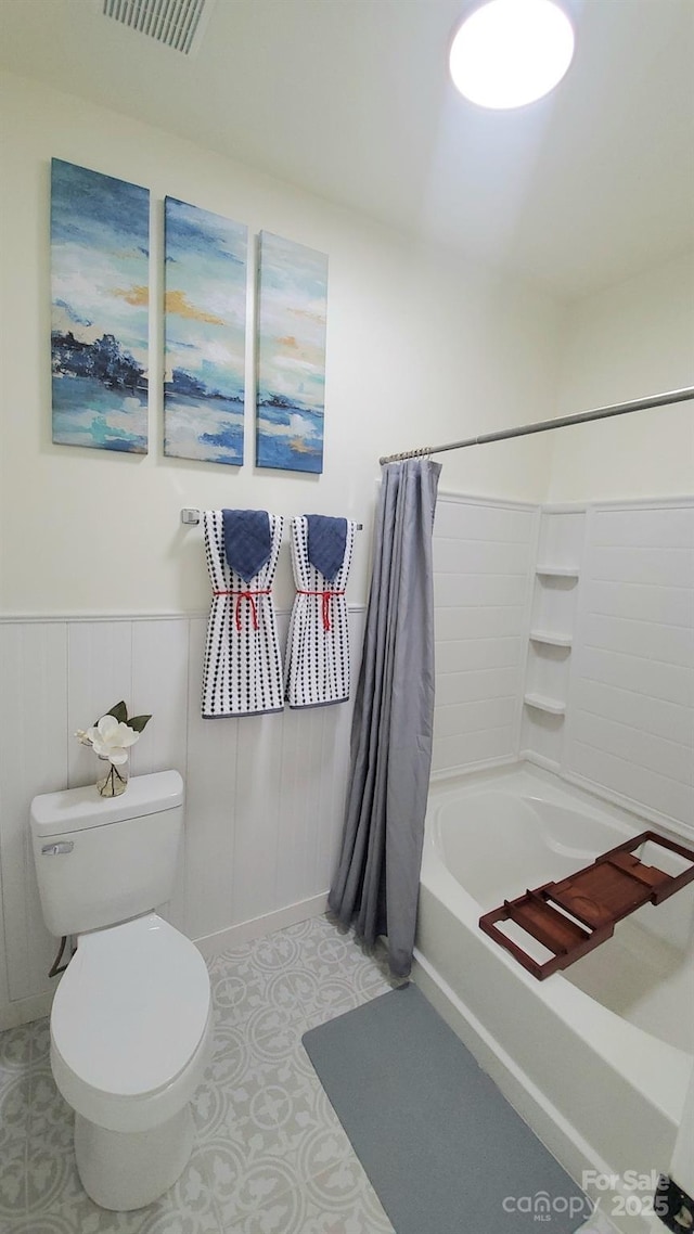 bathroom featuring toilet and shower / tub combo