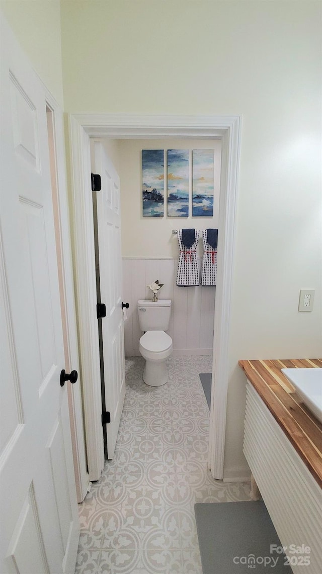 bathroom featuring tile patterned floors, toilet, and vanity