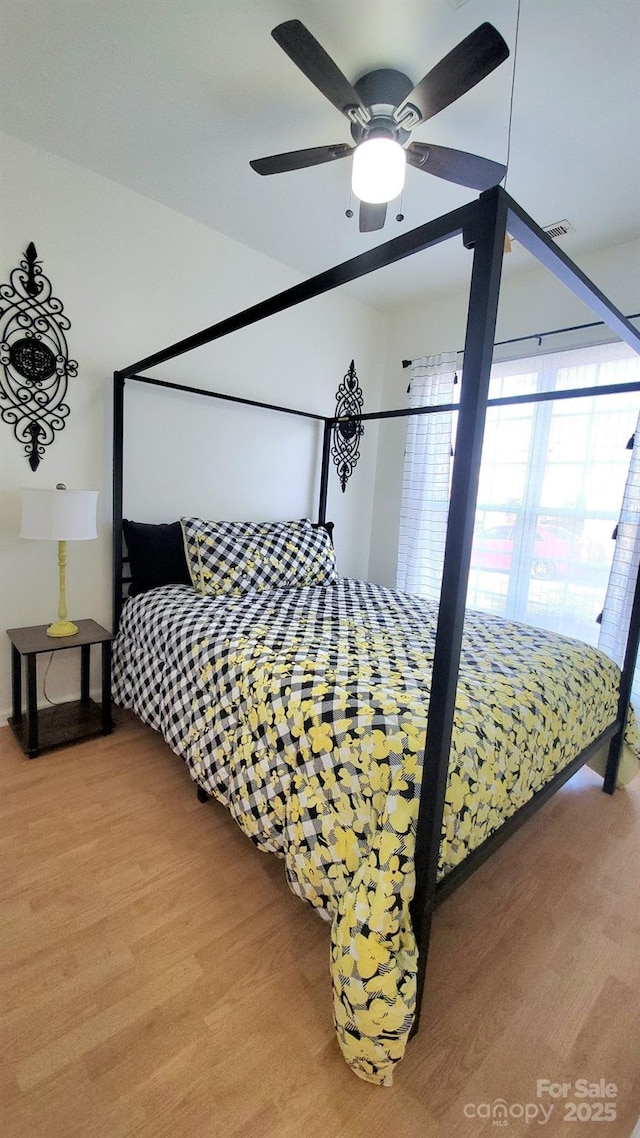 bedroom with ceiling fan and hardwood / wood-style flooring