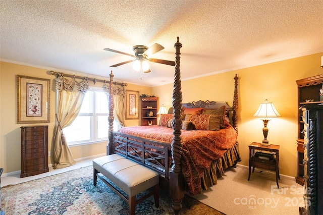 bedroom featuring ceiling fan, carpet, a textured ceiling, and ornamental molding