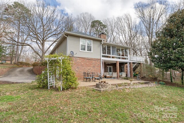 124 Muirfield Dr, Kings Mountain, NC 28086 - rear view of property with a sunroom, brick siding, a patio area, a chimney, and a yard