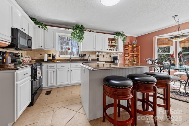 124 Muirfield Dr, Kings Mountain, NC 28086 - kitchen with black appliances, white cabinets, tasteful backsplash, and a textured ceiling