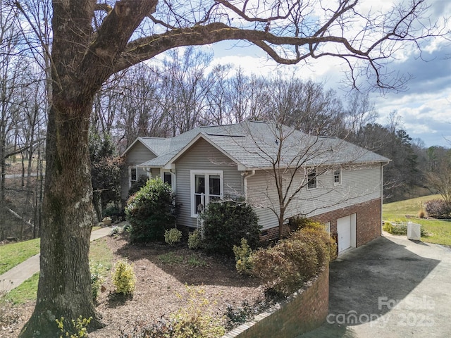 124 Muirfield Dr, Kings Mountain, NC 28086 - view of side of property with concrete driveway, an attached garage, and roof with shingles