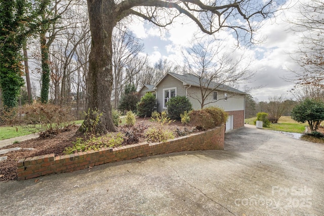 124 Muirfield Dr, Kings Mountain, NC 28086 - view of home's exterior with concrete driveway, an attached garage, and brick siding