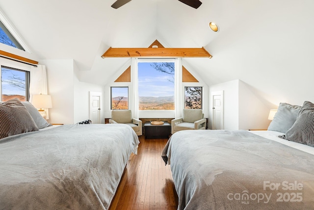 bedroom featuring hardwood / wood-style floors, lofted ceiling with beams, and ceiling fan