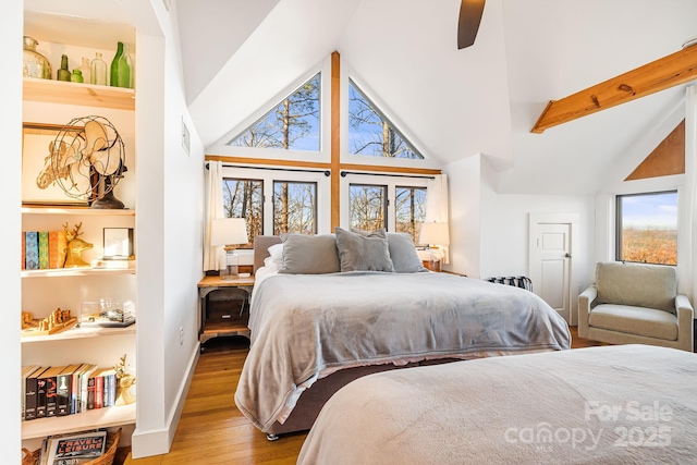 bedroom with ceiling fan, beam ceiling, high vaulted ceiling, and wood-type flooring