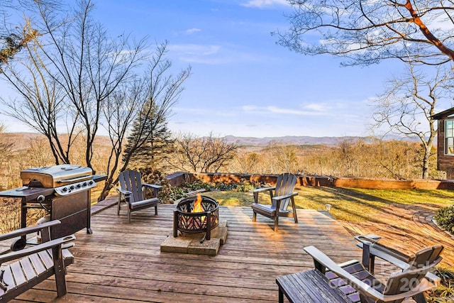 deck with area for grilling and a mountain view