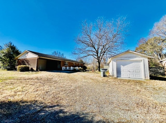 view of home's exterior featuring a garage and an outbuilding