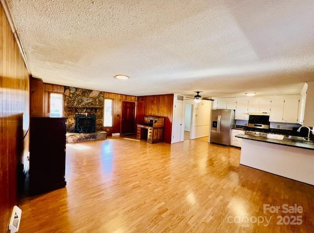 kitchen featuring appliances with stainless steel finishes, a textured ceiling, ceiling fan, sink, and white cabinetry