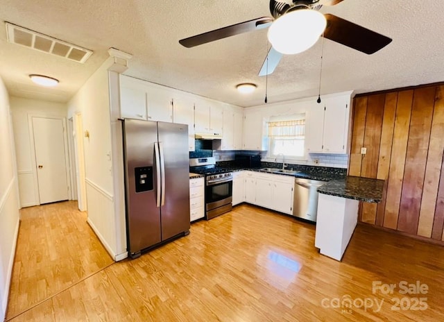 kitchen featuring white cabinets, sink, appliances with stainless steel finishes, and a textured ceiling