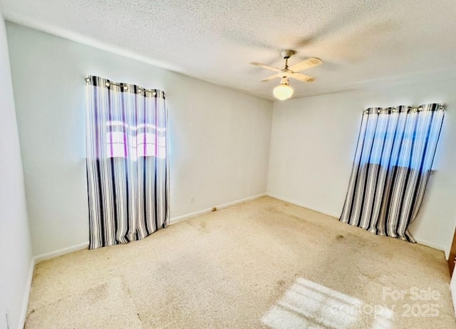 spare room with carpet flooring, a textured ceiling, and ceiling fan