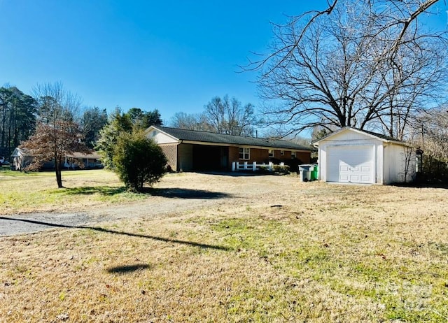 exterior space with a yard, an outdoor structure, and a garage