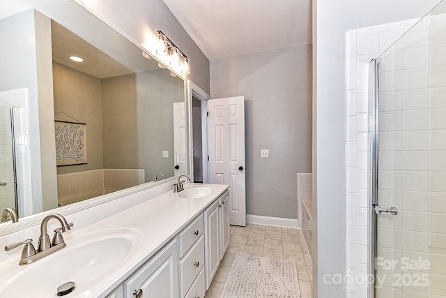 bathroom featuring tile patterned flooring, shower with separate bathtub, and vanity